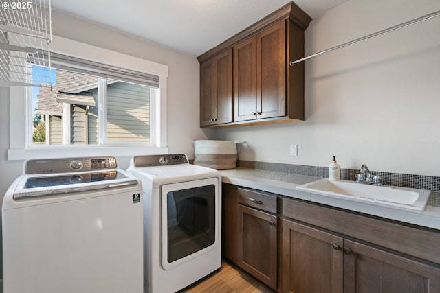 12721 Cottonwood Ave, Oregon City, OR 97045 - laundry room featuring cabinet space, separate washer and dryer, and light wood-style flooring