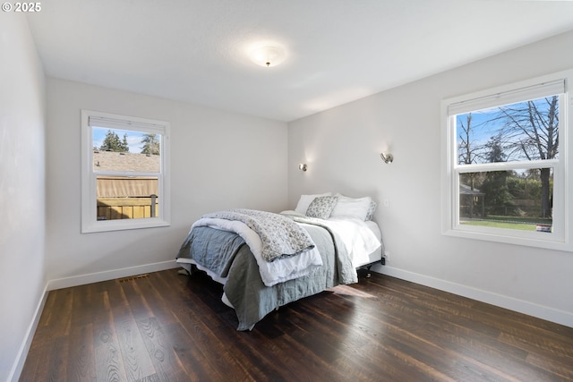 bedroom featuring baseboards and wood finished floors