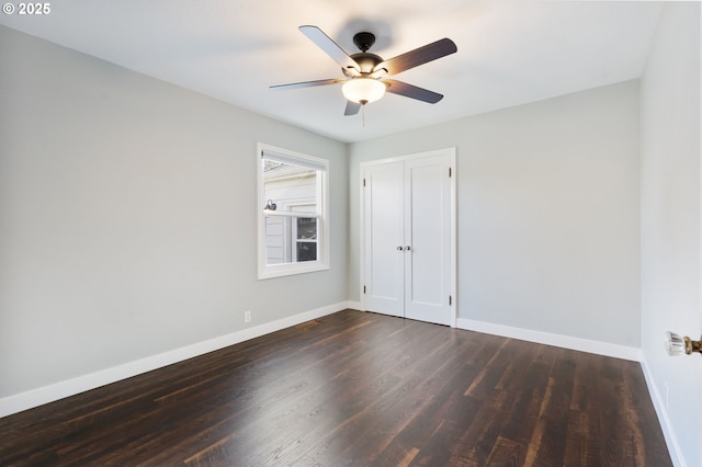 spare room featuring ceiling fan, wood finished floors, and baseboards