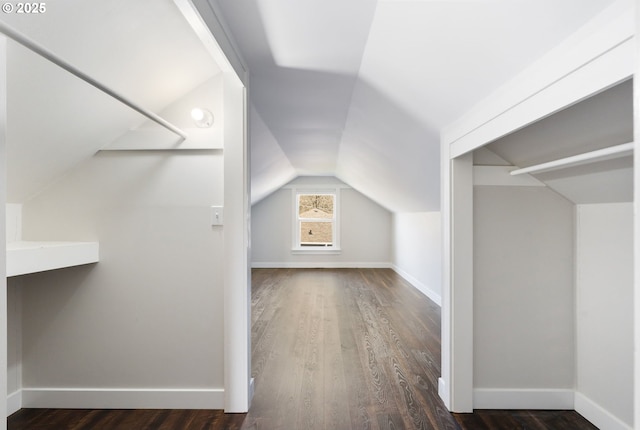 additional living space featuring baseboards, vaulted ceiling, and wood finished floors