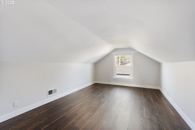 bonus room with lofted ceiling, wood finished floors, visible vents, and baseboards