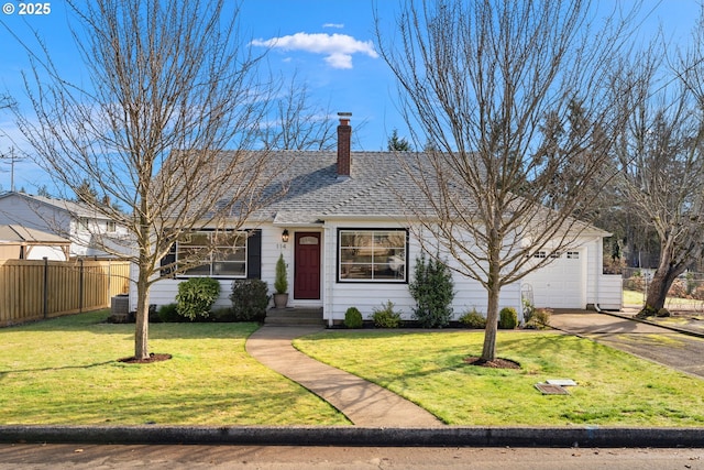 single story home with a front lawn, fence, driveway, and an attached garage