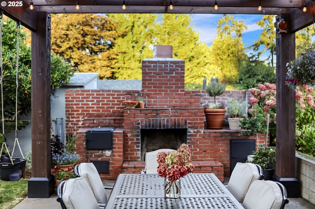 view of patio with an outdoor brick fireplace and outdoor dining area