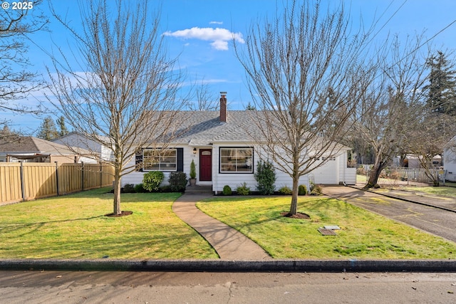 view of front of home with a garage, a chimney, aphalt driveway, fence, and a front yard