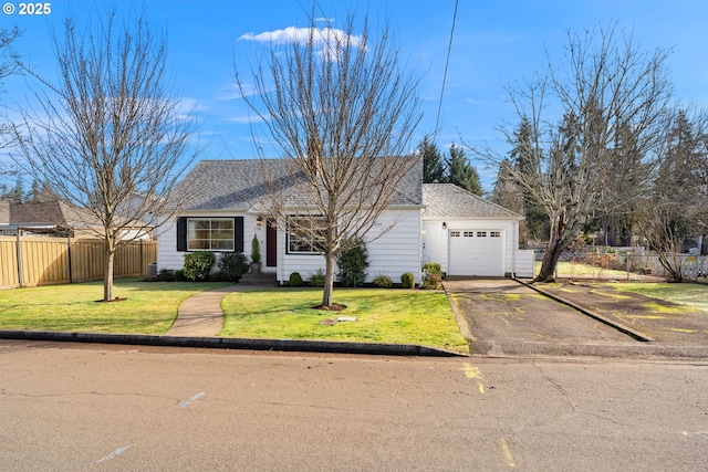 view of front facade featuring driveway, a garage, fence, and a front yard