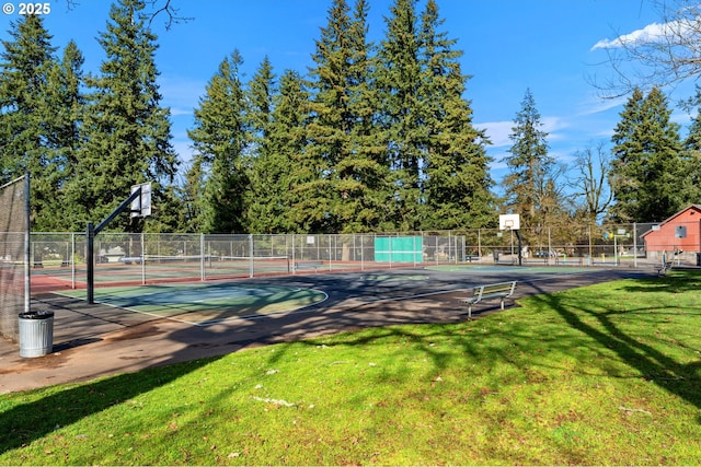 exterior space featuring community basketball court, a lawn, and fence