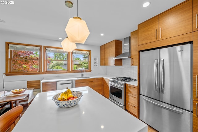 3905 NE Holman St, Portland, OR 97211 - kitchen featuring appliances with stainless steel finishes, wall chimney exhaust hood, light countertops, modern cabinets, and recessed lighting