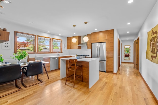 3905 NE Holman St, Portland, OR 97211 - kitchen with appliances with stainless steel finishes, light countertops, modern cabinets, a kitchen island, and brown cabinetry