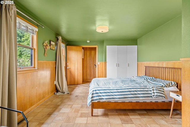 3905 NE Holman St, Portland, OR 97211 - bedroom featuring a wainscoted wall and wooden walls