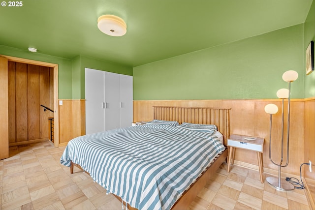 3905 NE Holman St, Portland, OR 97211 - bedroom with a wainscoted wall, a closet, tile patterned floors, and wood walls