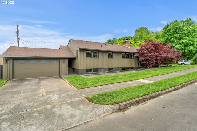 3905 NE Holman St, Portland, OR 97211 - view of front of home featuring concrete driveway, an attached garage, a front lawn, and a chimney