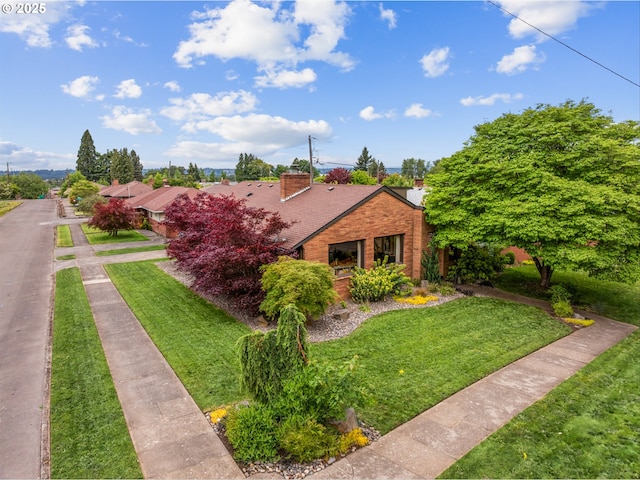 3905 NE Holman St, Portland, OR 97211 - view of front of house with a chimney, a front lawn, and brick siding