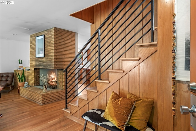 3905 NE Holman St, Portland, OR 97211 - staircase featuring wood finished floors and a fireplace