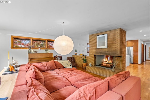 3905 NE Holman St, Portland, OR 97211 - living area with light wood-style flooring, recessed lighting, and a fireplace