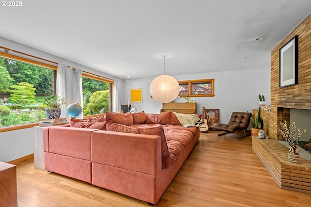 3905 NE Holman St, Portland, OR 97211 - living room with light wood finished floors and a brick fireplace