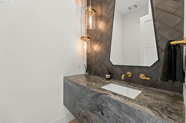 bathroom featuring decorative backsplash and vanity