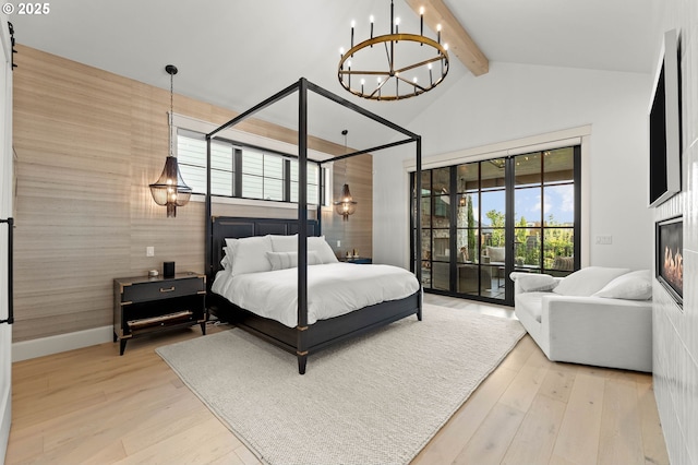 bedroom with hardwood / wood-style flooring, lofted ceiling with beams, access to exterior, and an inviting chandelier