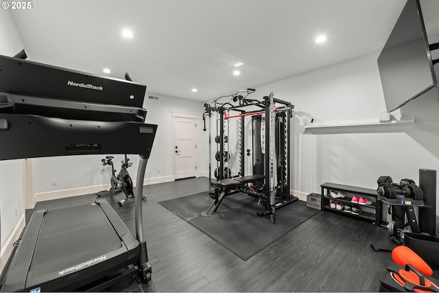 exercise room featuring dark hardwood / wood-style floors