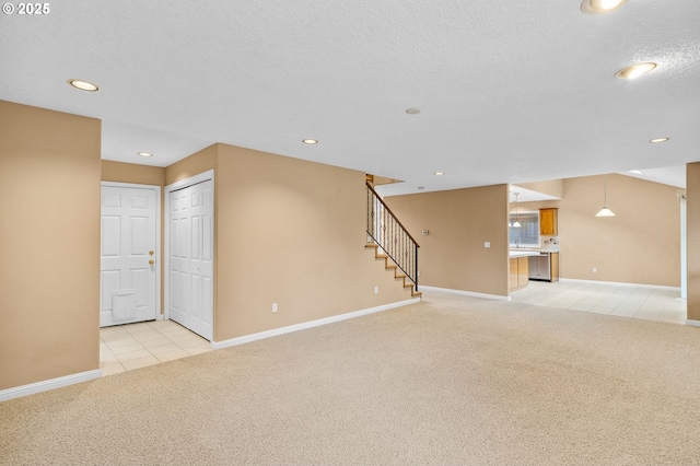 unfurnished living room featuring stairs, recessed lighting, baseboards, and light carpet