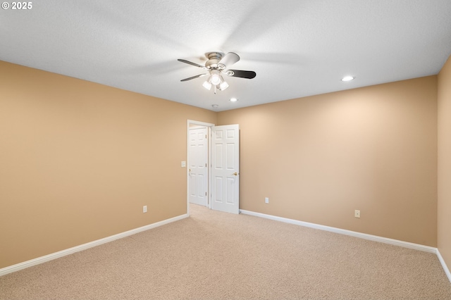 spare room with baseboards, recessed lighting, ceiling fan, and light carpet