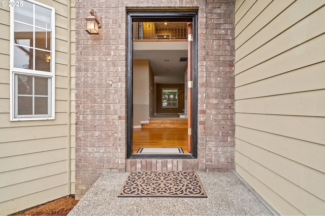 property entrance featuring brick siding