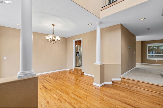 interior space featuring recessed lighting, ornate columns, and light wood-style flooring