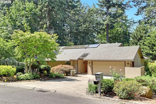 128 Del Prado St, Lake Oswego, OR 97035 - view of front of home featuring a garage, concrete driveway, and a tile roof