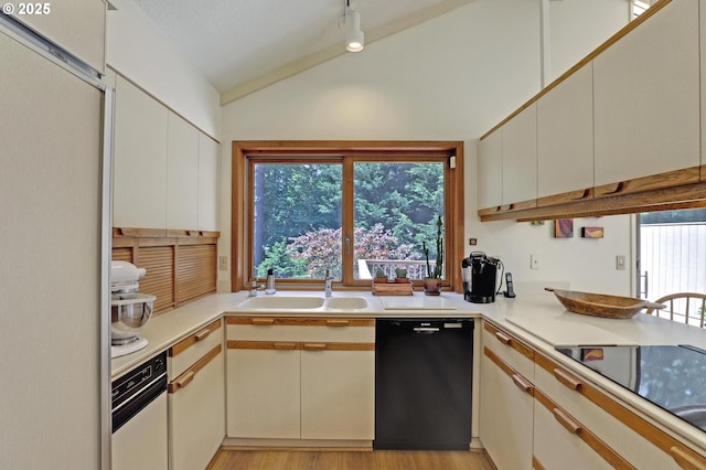 128 Del Prado St, Lake Oswego, OR 97035 - kitchen featuring black appliances, vaulted ceiling, healthy amount of natural light, and light countertops