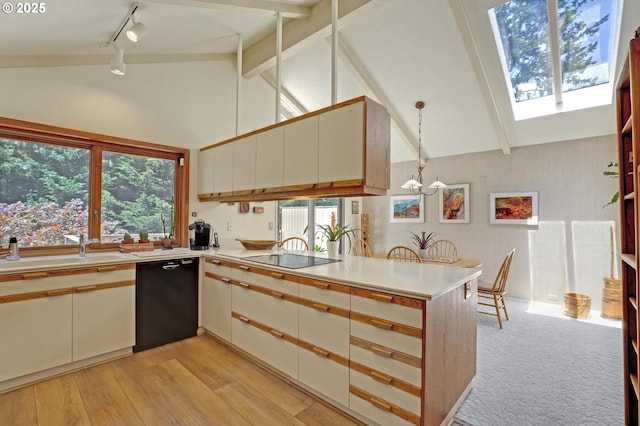128 Del Prado St, Lake Oswego, OR 97035 - kitchen featuring black appliances, track lighting, light countertops, a peninsula, and beam ceiling