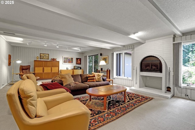 128 Del Prado St, Lake Oswego, OR 97035 - living area with carpet flooring, beam ceiling, a textured ceiling, and a fireplace