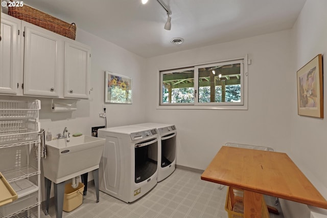 128 Del Prado St, Lake Oswego, OR 97035 - laundry area with washer and clothes dryer, cabinet space, light floors, and rail lighting
