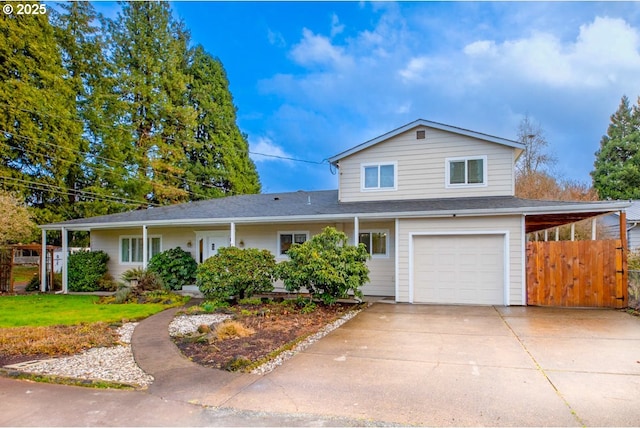 view of front of house with driveway, an attached garage, and fence