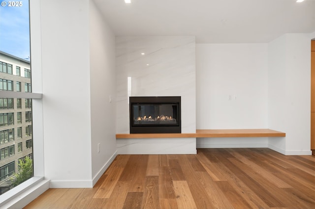 590 Waterfront Way Unit 500, Vancouver, WA 98660 - unfurnished living room with wood finished floors, baseboards, and a glass covered fireplace