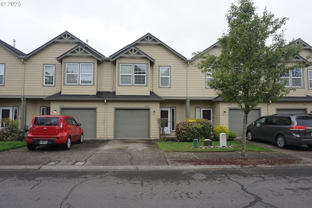 multi unit property with an attached garage and driveway