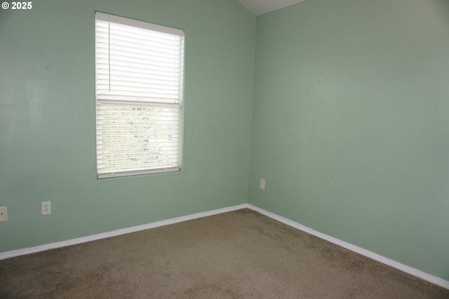 carpeted empty room with baseboards