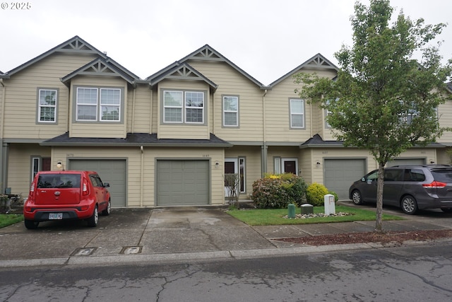 multi unit property with an attached garage and driveway