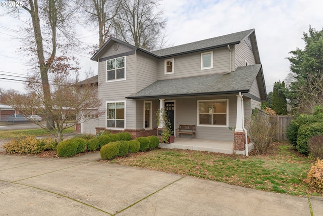 view of front of property with covered porch and a front lawn