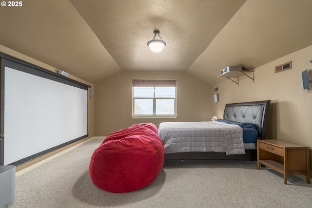 carpeted bedroom with vaulted ceiling