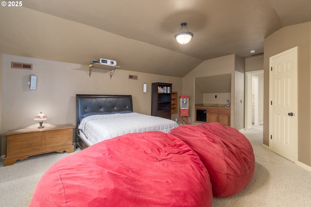 bedroom featuring lofted ceiling and light colored carpet