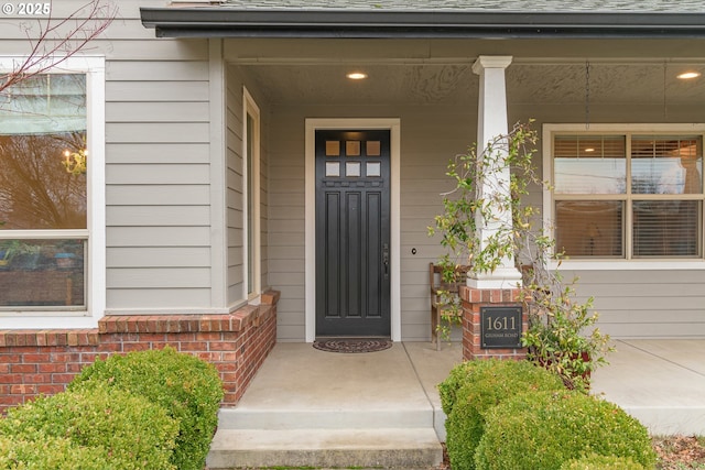 view of exterior entry featuring a porch