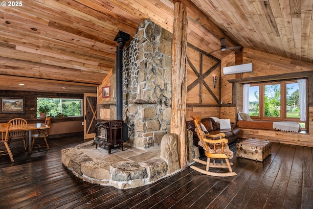 sitting room featuring wooden ceiling, a wood stove, vaulted ceiling, wood-type flooring, and wood walls