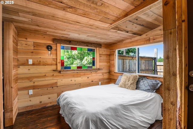 bedroom featuring wooden ceiling, hardwood / wood-style floors, and wooden walls