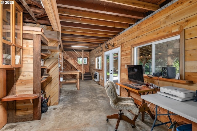 below grade area featuring wood walls and an office area