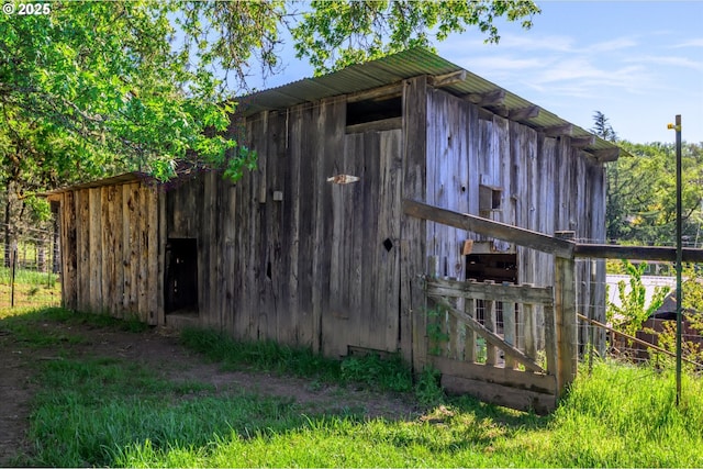 view of outbuilding featuring an outbuilding and fence