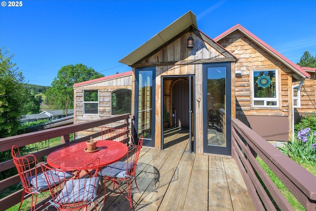 wooden terrace featuring outdoor dining space