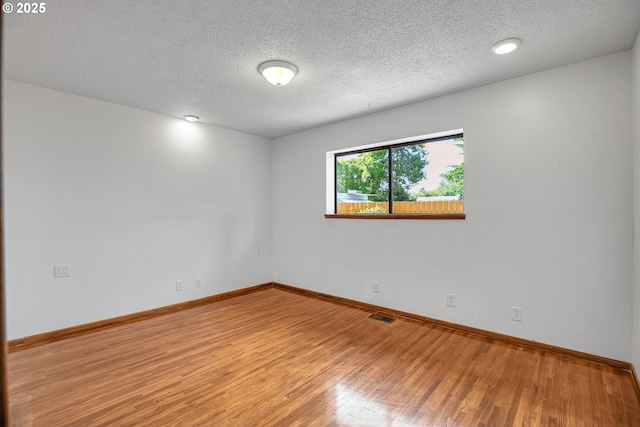 904 SE 223rd Ave, Gresham, OR 97030 - spare room featuring a textured ceiling and wood finished floors
