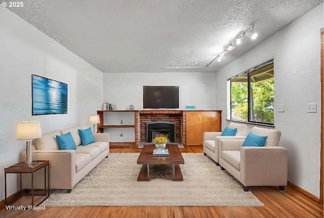 904 SE 223rd Ave, Gresham, OR 97030 - living area featuring wood finished floors, track lighting, and a fireplace
