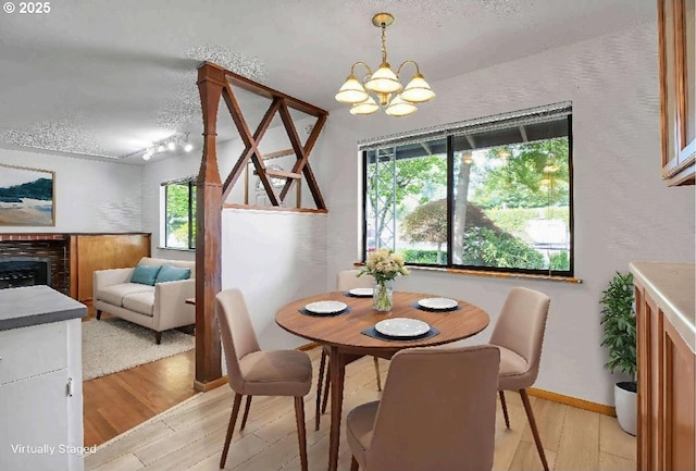 904 SE 223rd Ave, Gresham, OR 97030 - dining area featuring light wood finished floors, a textured ceiling, a chandelier, and rail lighting