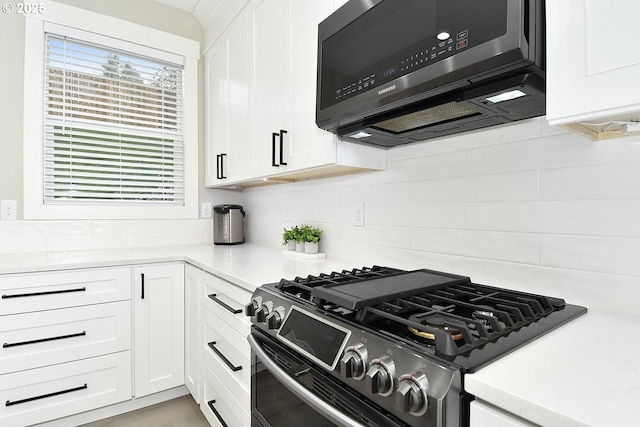 kitchen featuring white cabinetry, stainless steel gas range, and light countertops