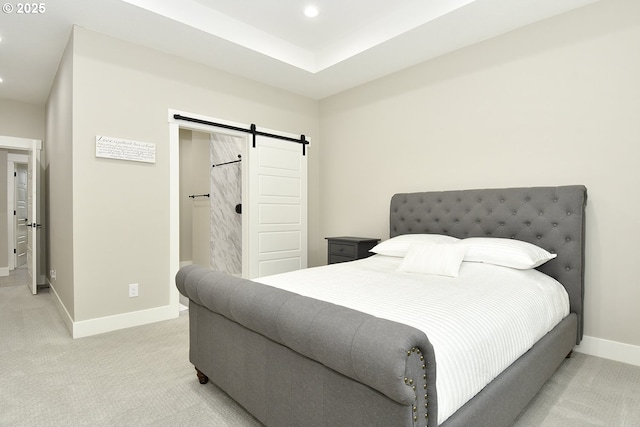 bedroom with a barn door, recessed lighting, light colored carpet, and baseboards